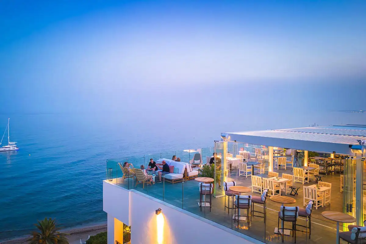 Lounge seating and sea views at dusk on The Belvue rooftop Marbella