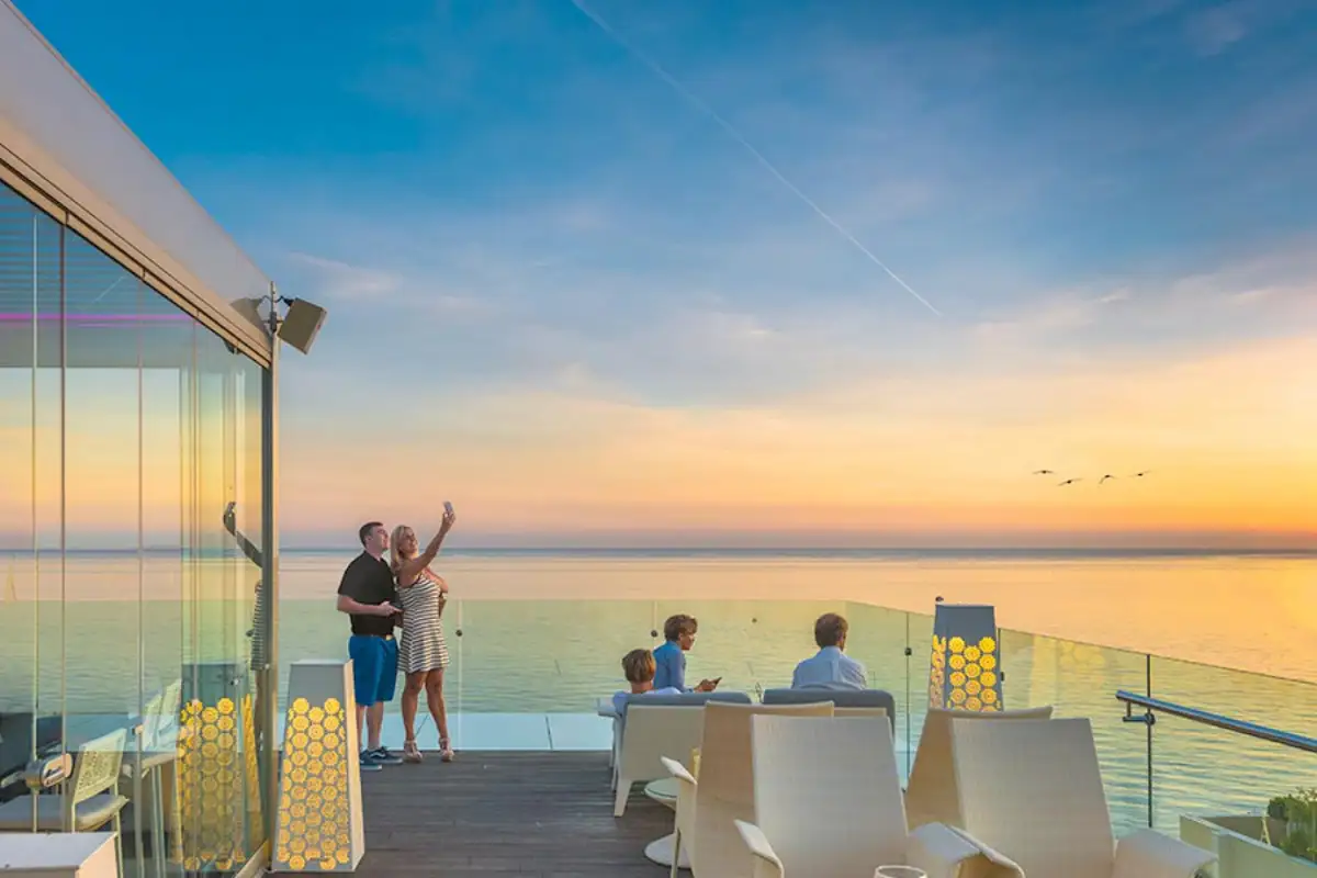 Guests enjoying the sunset over the sea at The Belvue rooftop Marbella