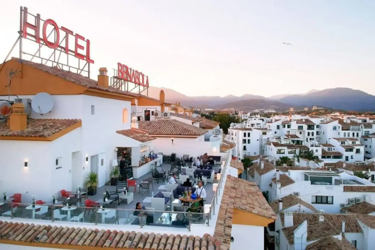 Rooftop terrace overlooking Puerto Banus town at dusk from Benabola Marbella