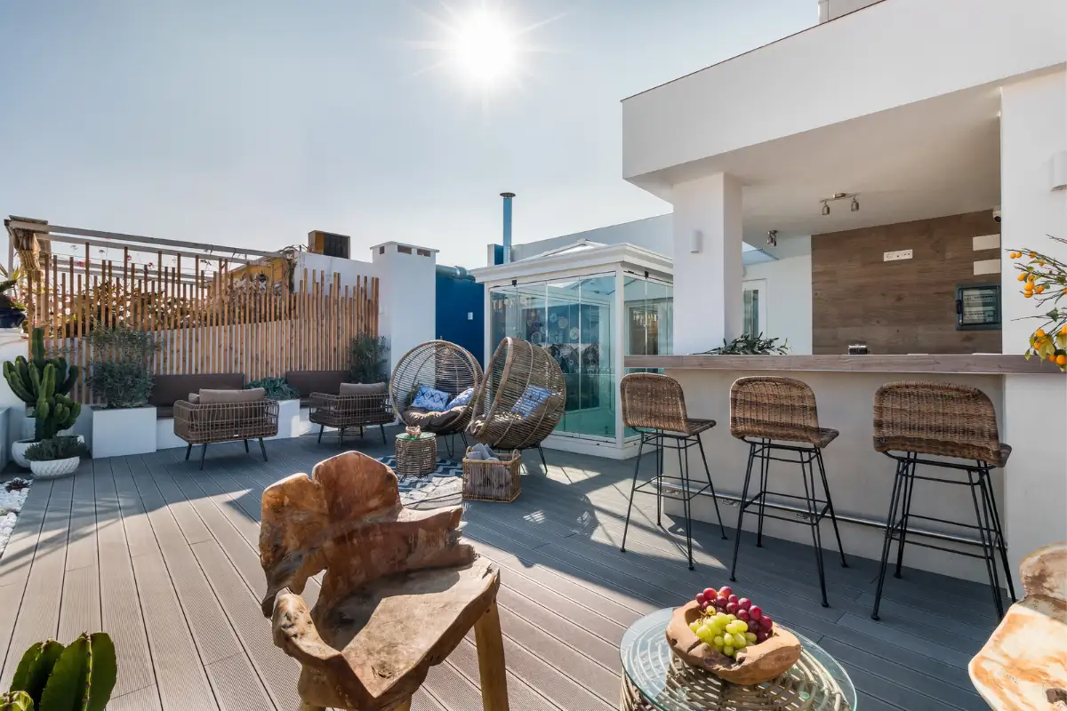 Rooftop terrace with bar stools and wicker seating at La Fonda, Marbella