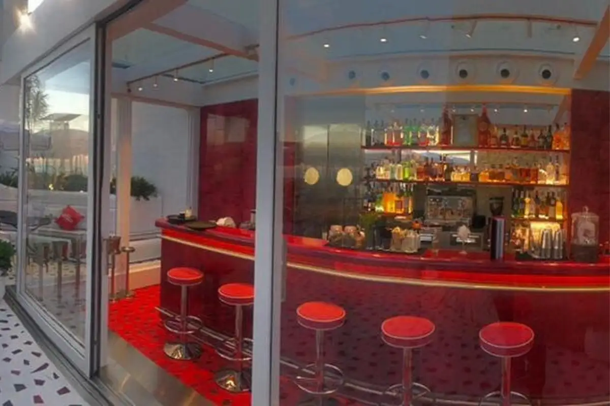 Glossy red cocktail bar with stools at Martini Bar by Dolce and Gabbana, Marbella