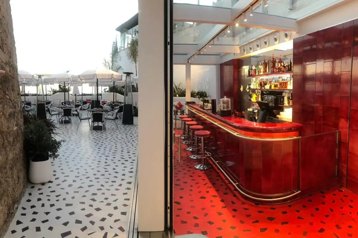 Tiled terrace beside the red interior bar at Martini Bar by Dolce and Gabbana, Marbella