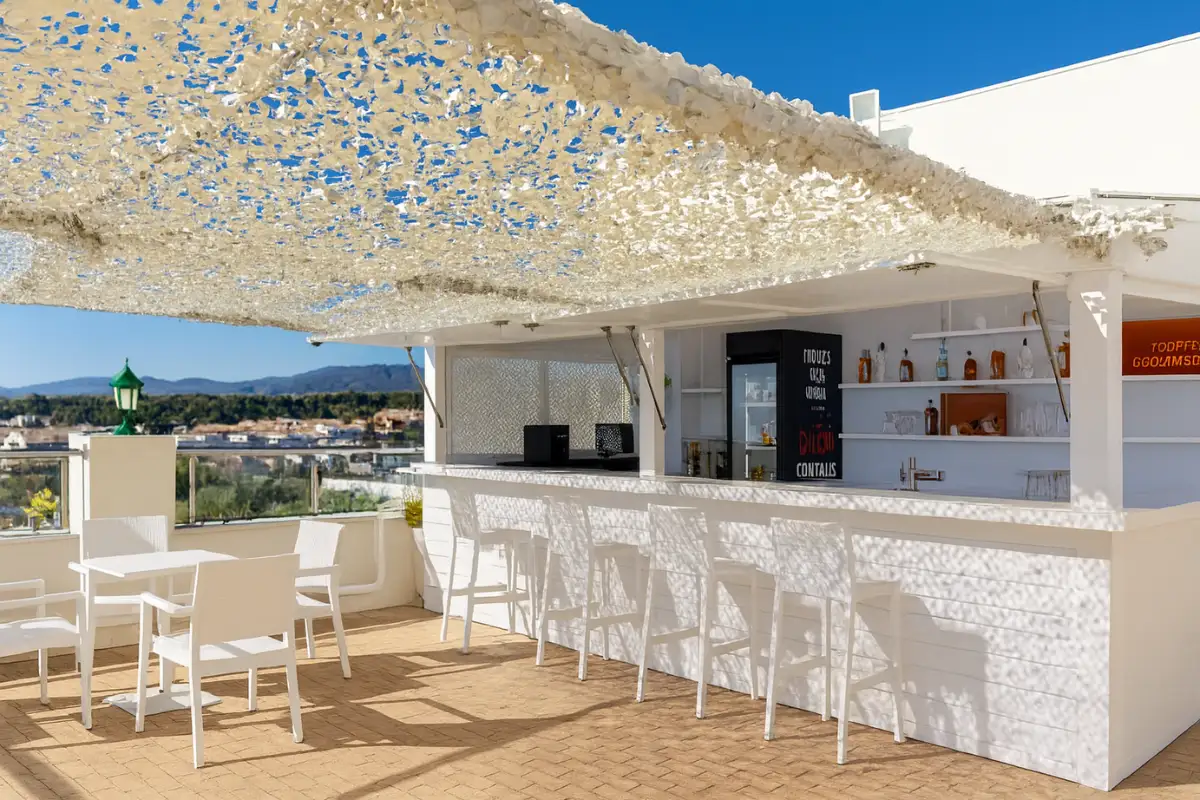 White rooftop bar counter and stools under a patterned canopy at Senator Hotel, Marbella