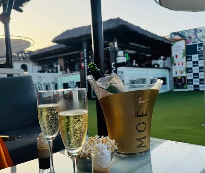 Cava glasses and a Moet ice bucket at sunset on the terrace at Buddha Lounge, Nerja