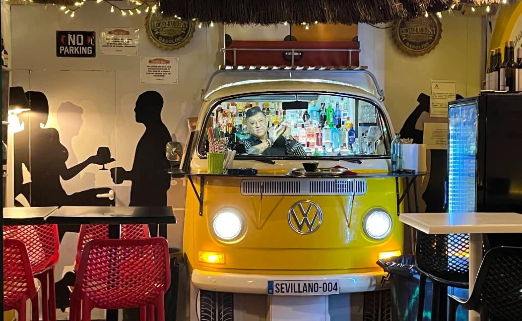 Yellow VW camper van converted into a cocktail bar at Volks Bar Nerja