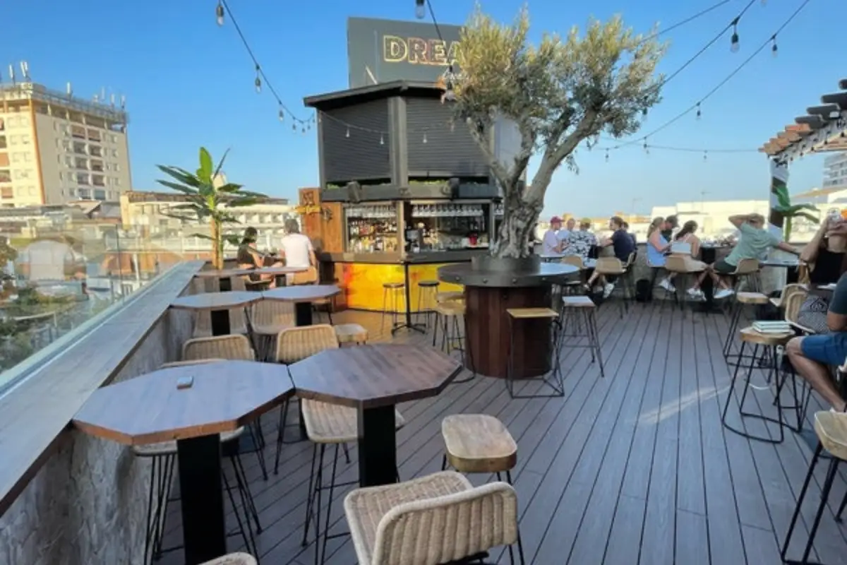Decked rooftop bar with stools and festoon lights at Clock Tower Torremolinos
