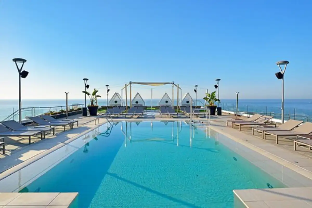 Rooftop pool with sun loungers and sea views at Sky and Sea Torremolinos