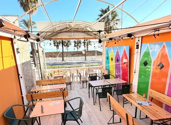 Painted surfboards lining the rooftop terrace at Flip Flop Bar, Benalmadena