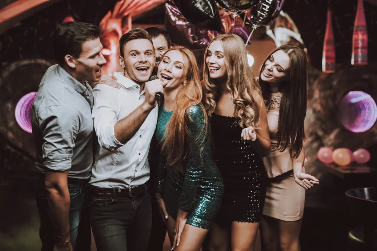 Friends singing and celebrating at a lively private party in Malaga