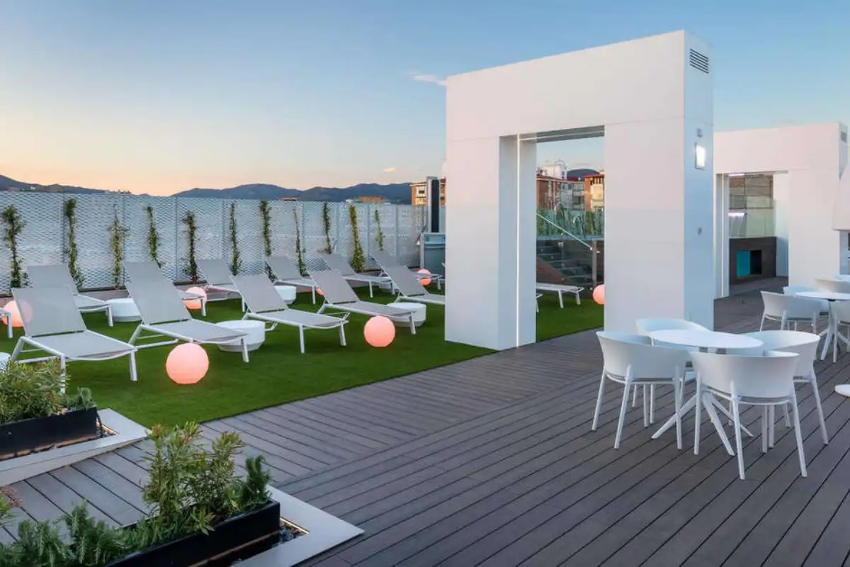 Sun loungers and pool deck at dusk on the B-Heaven rooftop in Malaga