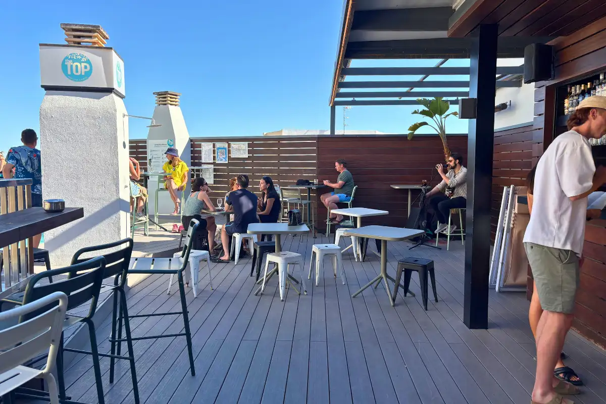 Tables and bar on the evening rooftop terrace at Hotel Molina Lario in Malaga