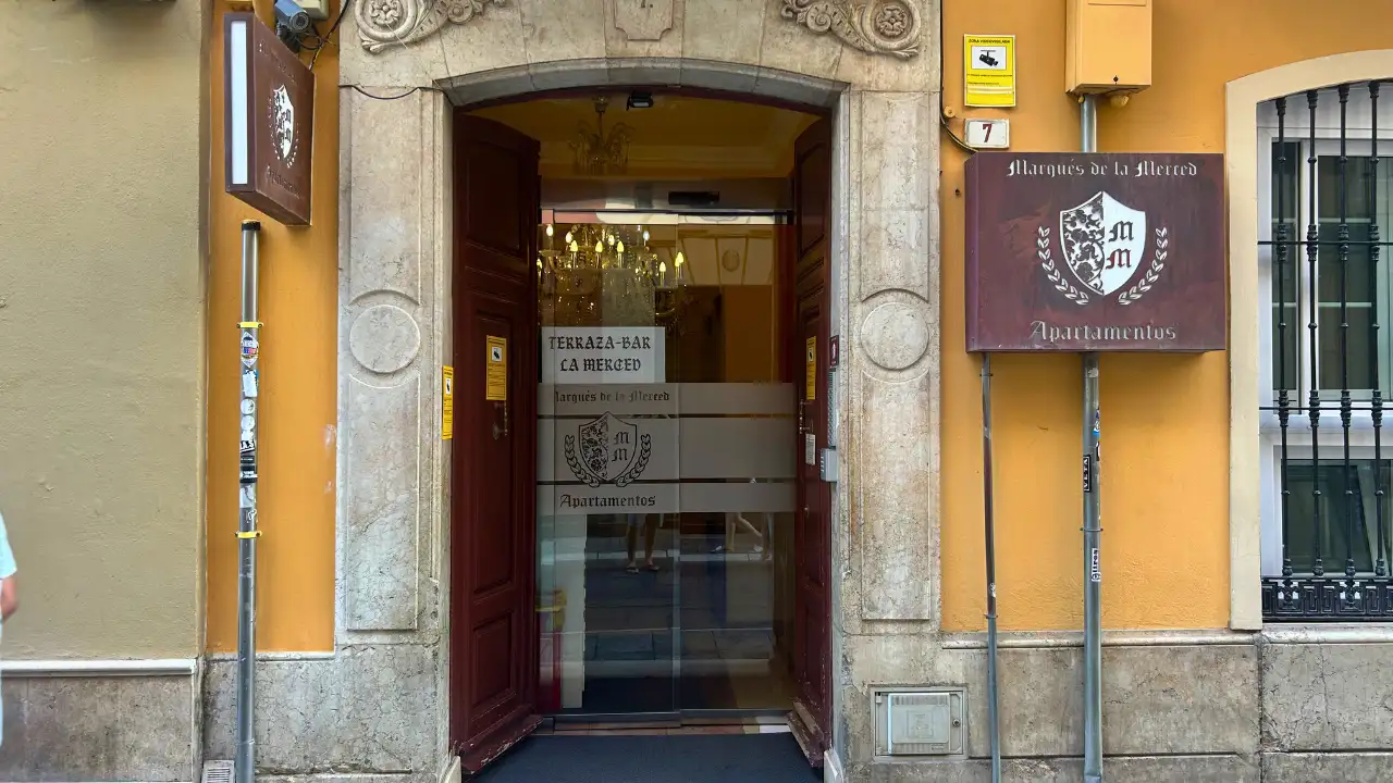 Arched street entrance and signage to Terraza La Merced in Malaga
