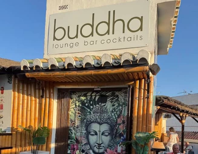 Bamboo entrance with Buddha artwork and signage at Buddha Lounge bar in Nerja