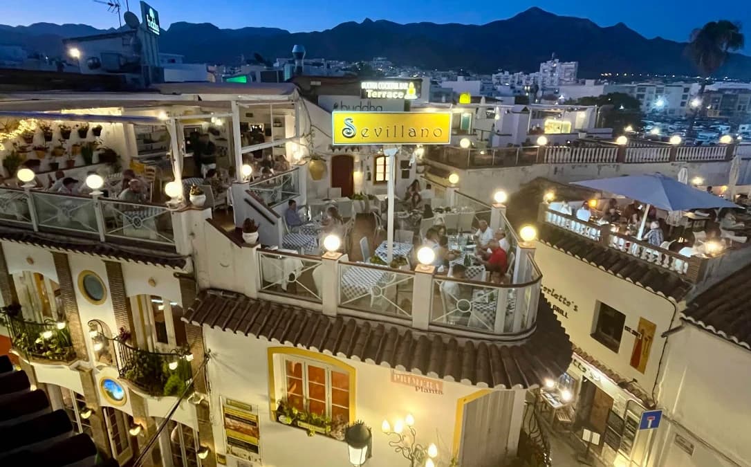Evening view over Nerja rooftops and mountains from Volks Bar terrace