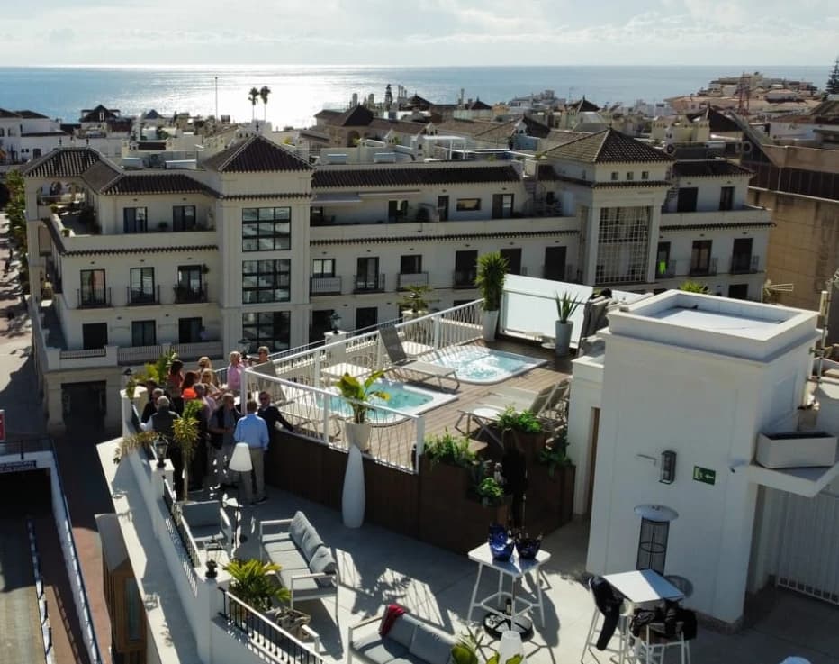 Aerial view of Yesca rooftop terrace and pool above Nerja with sea beyond