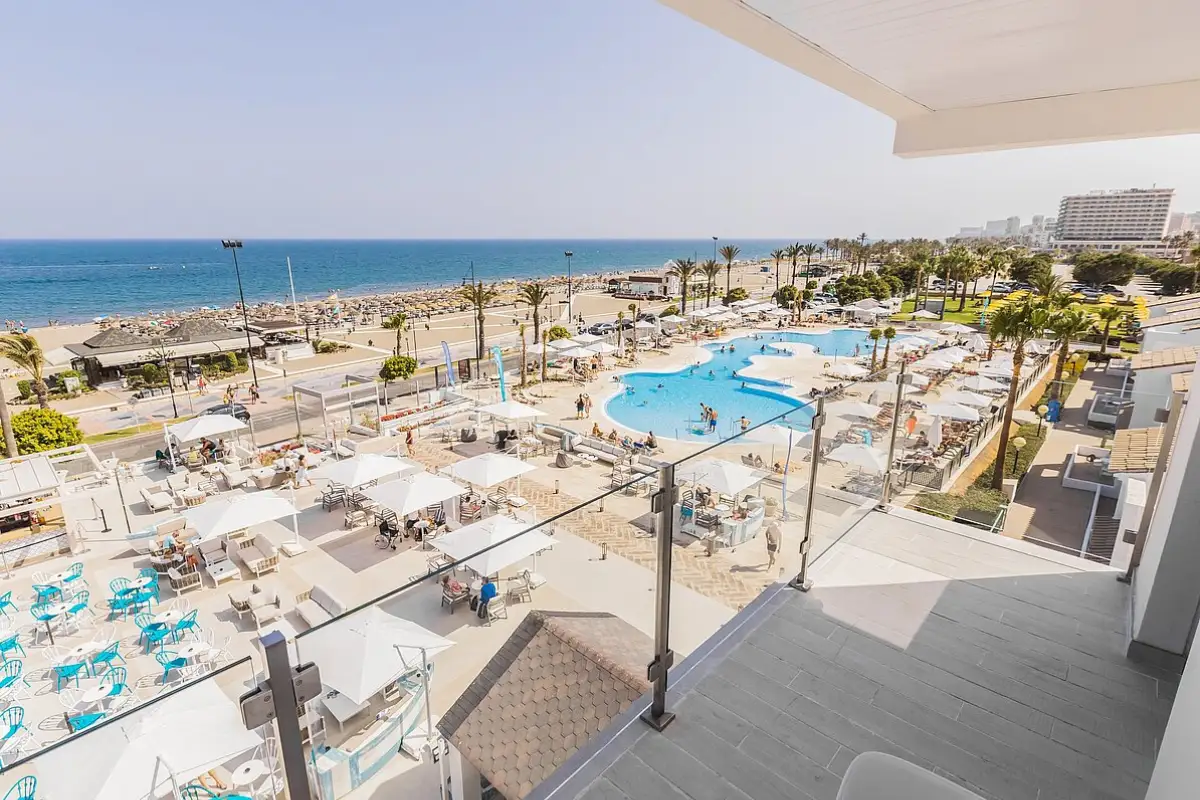 Balcony view over the large pool and beach at Occidental hotel in Torremolinos