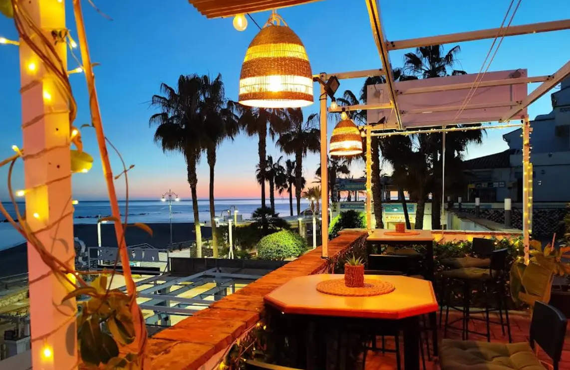 Sunset terrace with string lights at Almika Rooftop Benalmadena