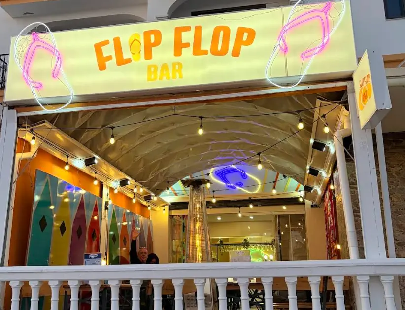 Bright yellow flip flop sign above the entrance to Flip Flop Bar, Benalmadena