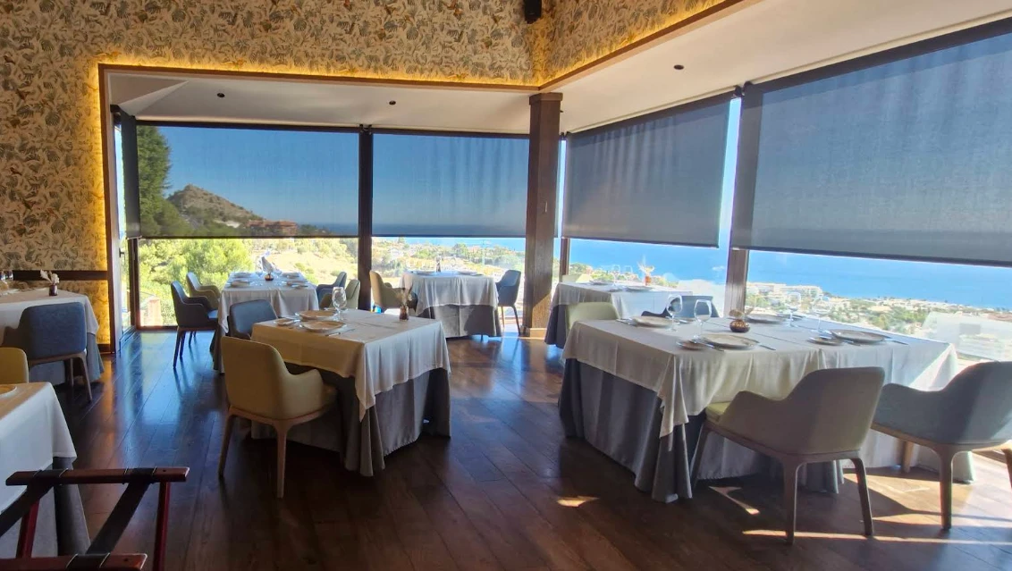Elegant dining room with panoramic sea and mountain views at El Higuerón, Fuengirola