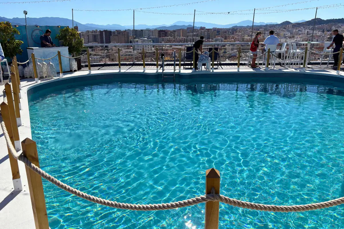 Round rooftop pool with rope barrier at AC Hotel Malaga Palacio
