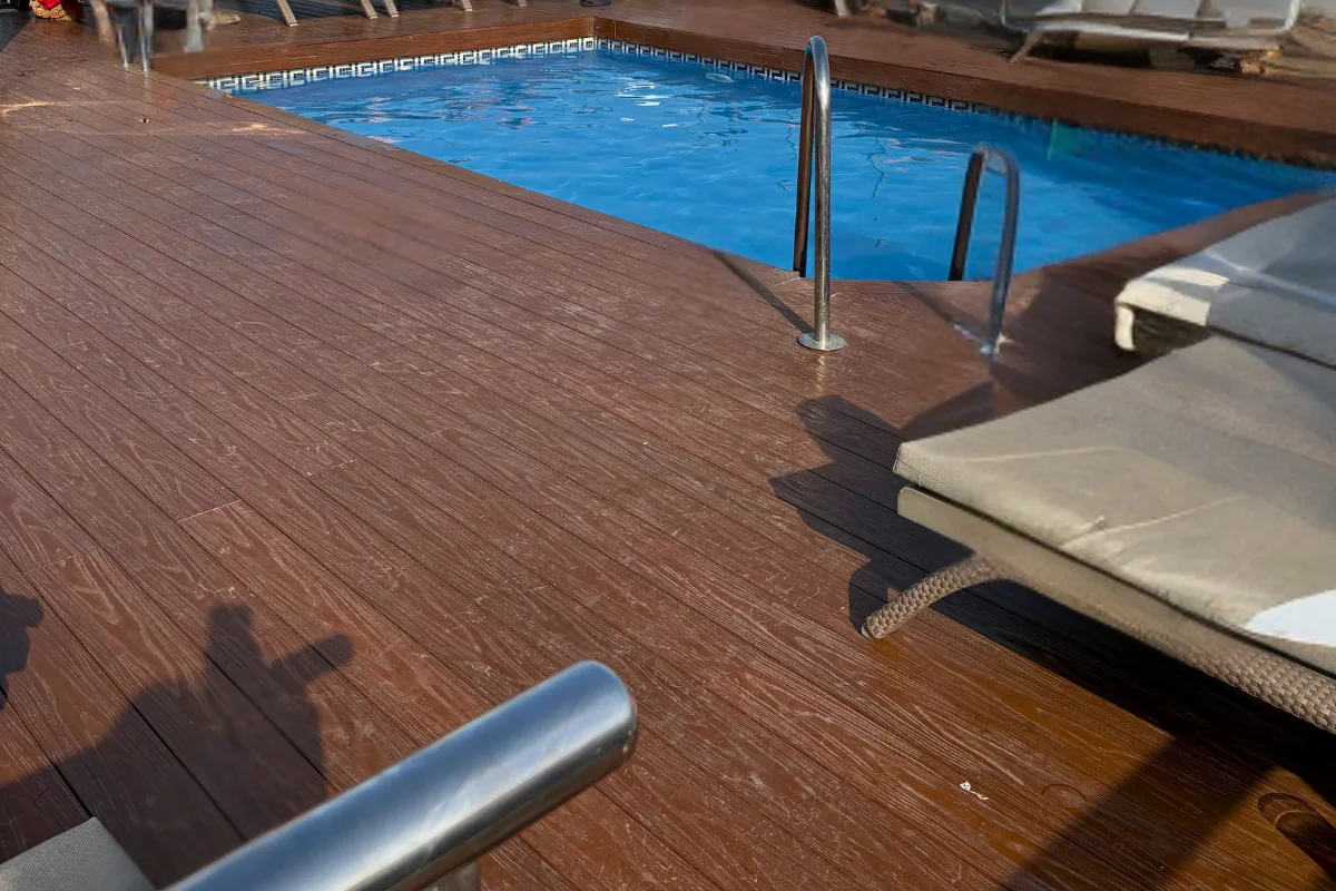 Wooden pool deck and sunbed beside the Aurea pool at Salles Malaga