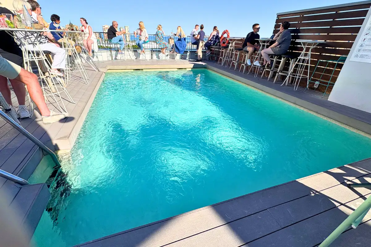 Turquoise rooftop plunge pool beside the bar at Hotel Molina Lario in Malaga