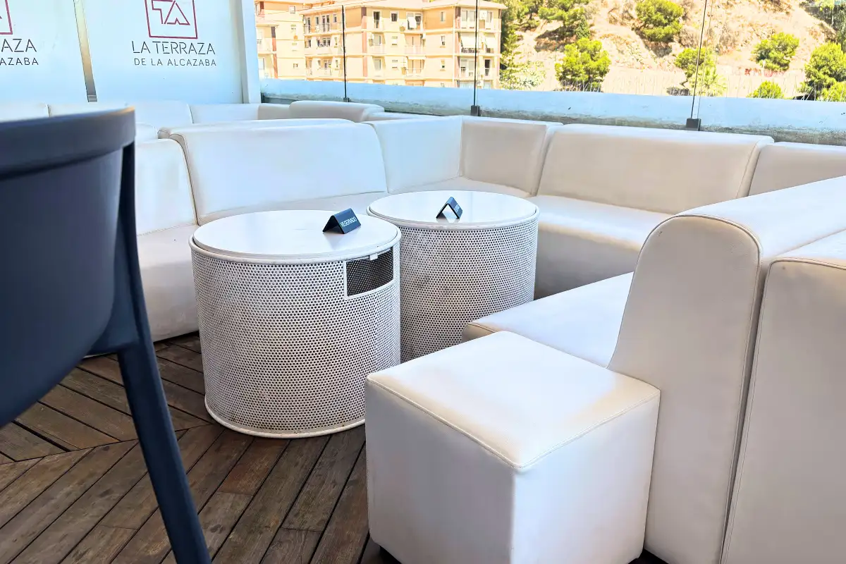 White lounge sofas on the rooftop deck at La Terraza de Alcazaba in Malaga