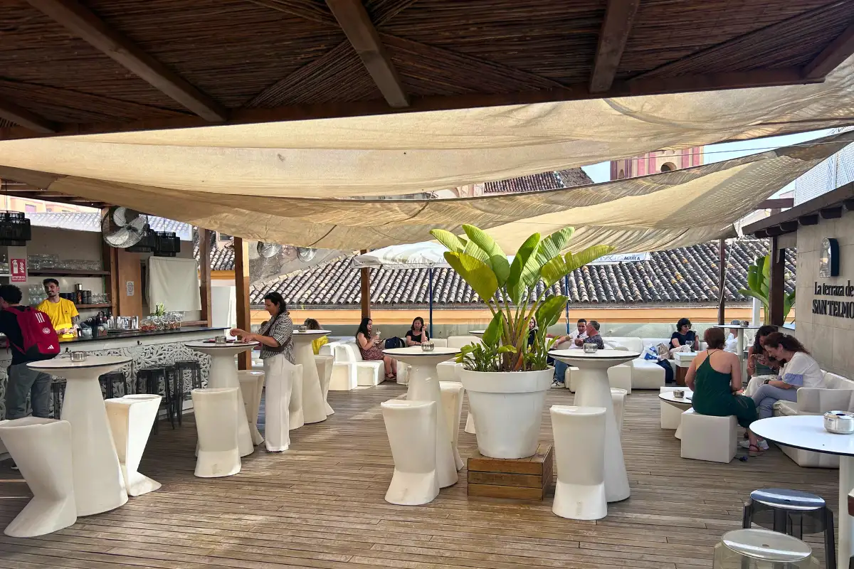 Shaded canopy seating with high tables on La Terraza de San Telmo rooftop in Malaga