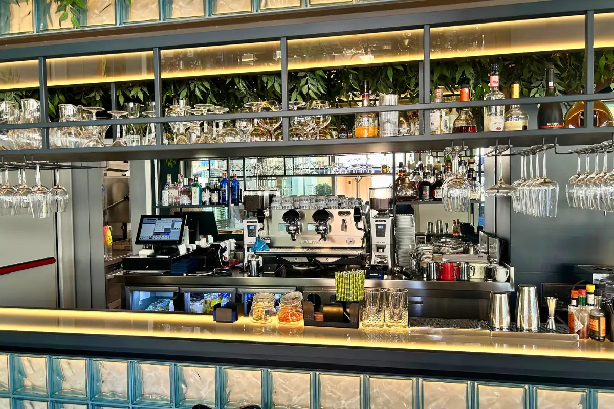Well-stocked cocktail bar counter with glassware at La Terraza Solecio