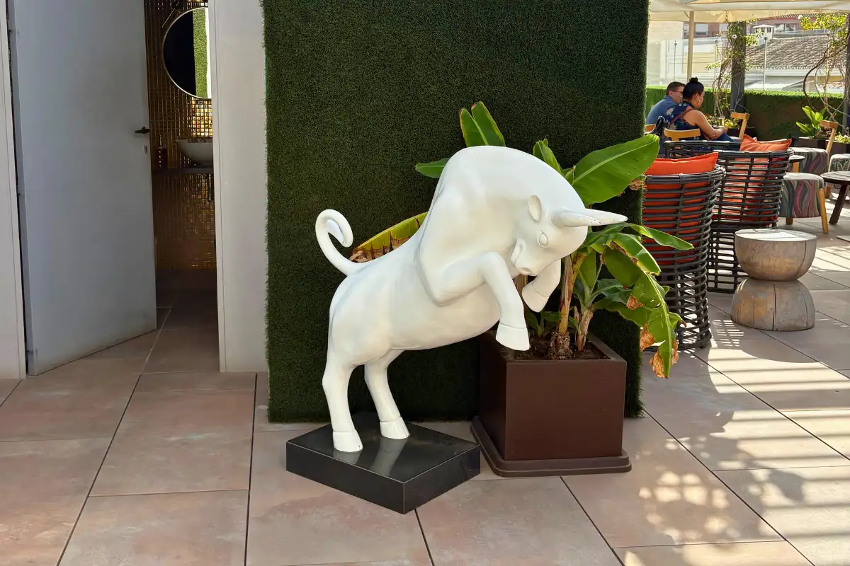 White leaping bull statue on the terrace at EFECTO Rooftop, Hotel Mariposa Malaga