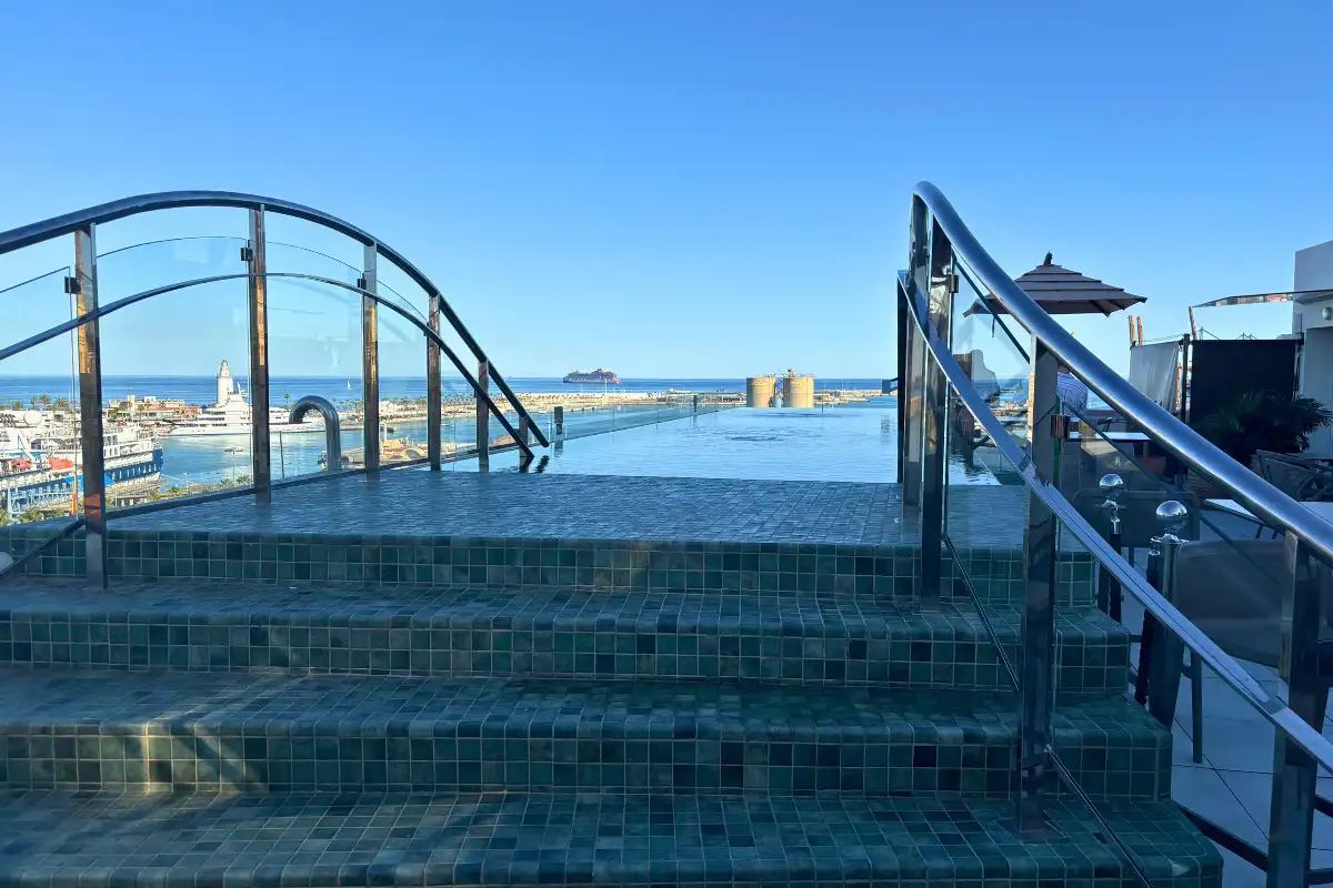 Glass infinity pool with sea and port views at Lolita Skyview in Malaga