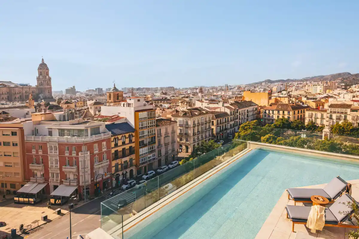 Rooftop pool with Malaga cathedral and city rooftops in the distance at ME Malaga