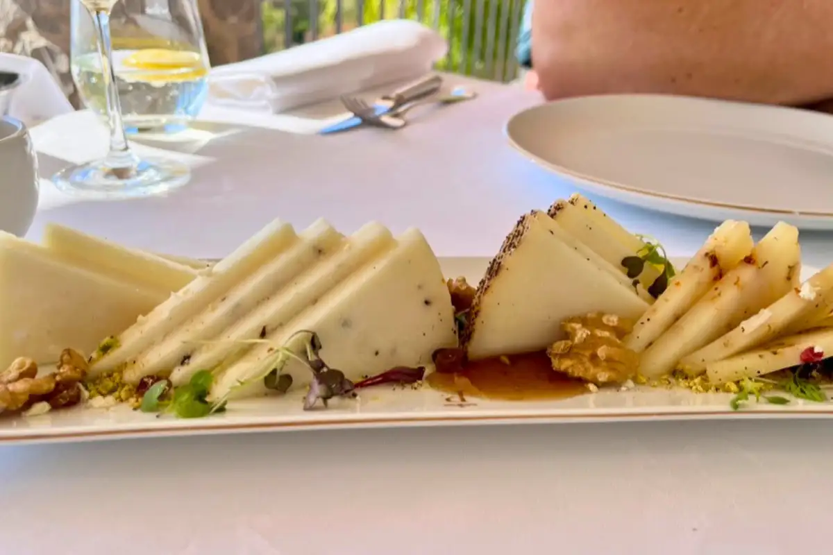 Spanish cheese platter with walnuts on a white tablecloth at Parador de Malaga Gibralfaro