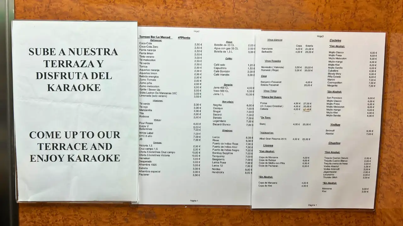 Karaoke invitation poster and song list on the wall at Terraza La Merced in Malaga