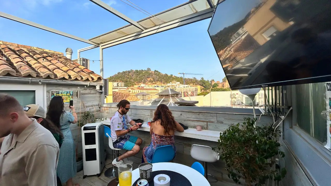 Guests on the rooftop terrace at sunset with hillside views at Terraza La Merced in Malaga