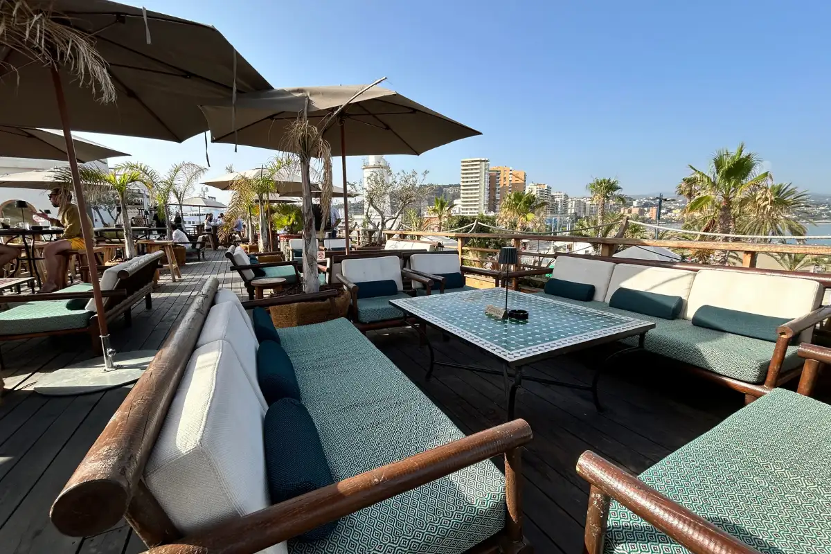 Lounge sofas and tables with sea views on the terrace at Trocadero de Las Botes in Malaga