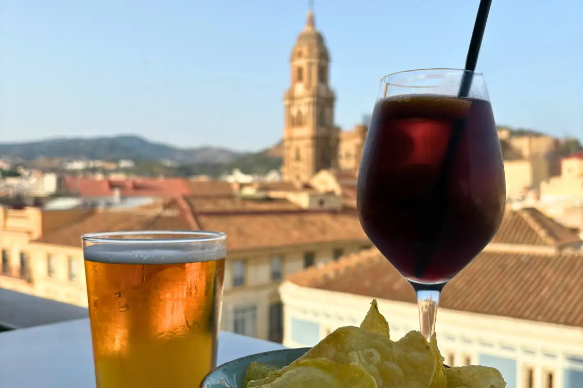 Beer and red drink with crisps and cathedral views at Vincci Larios Diez rooftop in Malaga