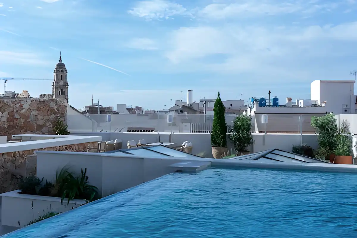 Rooftop pool overlooking Malaga cathedral tower and old town rooftops