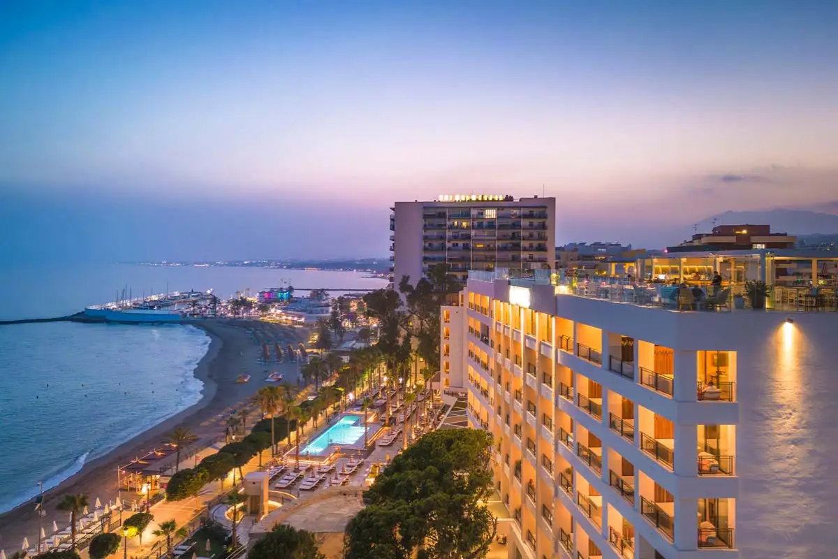 Aerial dusk view of El Fuerte hotel and Marbella coastline