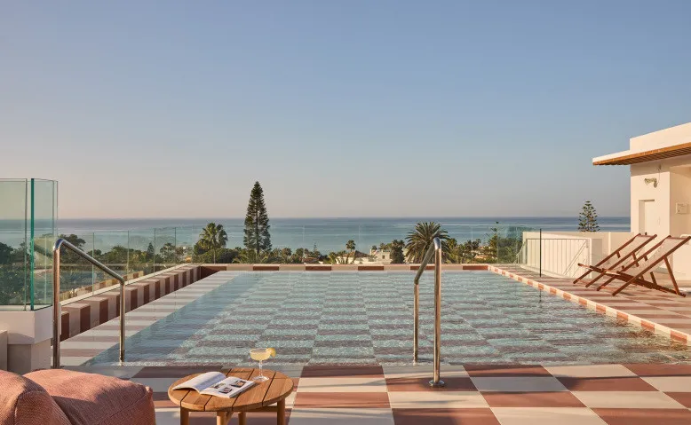 Rooftop pool with checkerboard deck and sea view at Escondido in Marbella