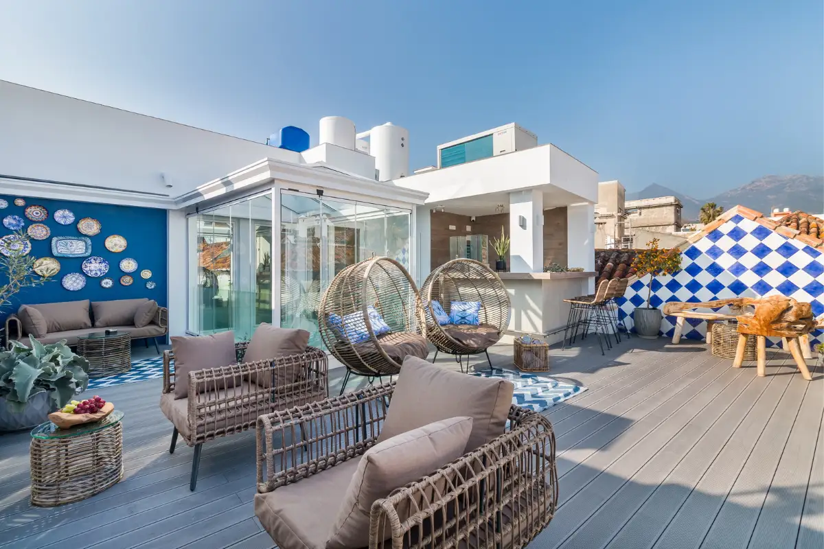 Lounge seating and hanging chairs on the rooftop terrace at La Fonda, Marbella