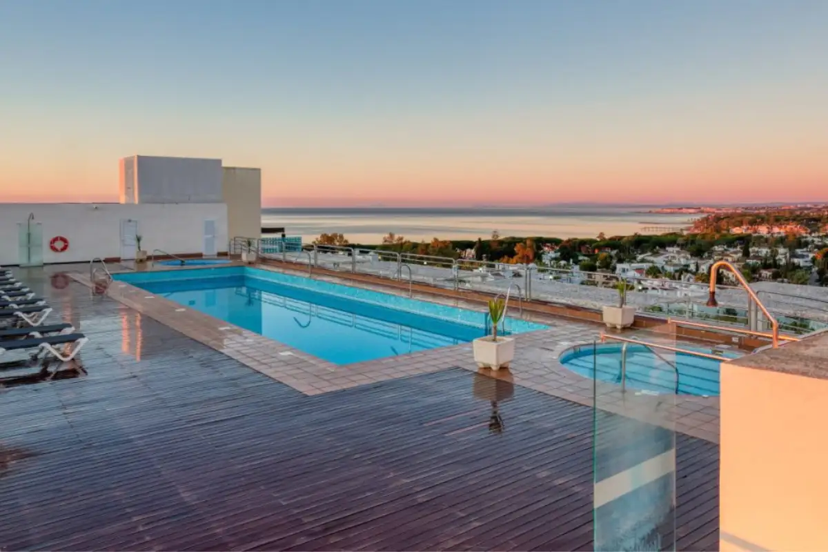 Rooftop pool and deck at sunset overlooking the sea at Senator Hotel, Marbella