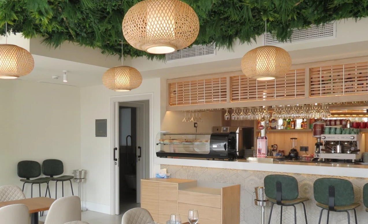 Bright interior bar with rattan pendant lights at Yesca in Nerja
