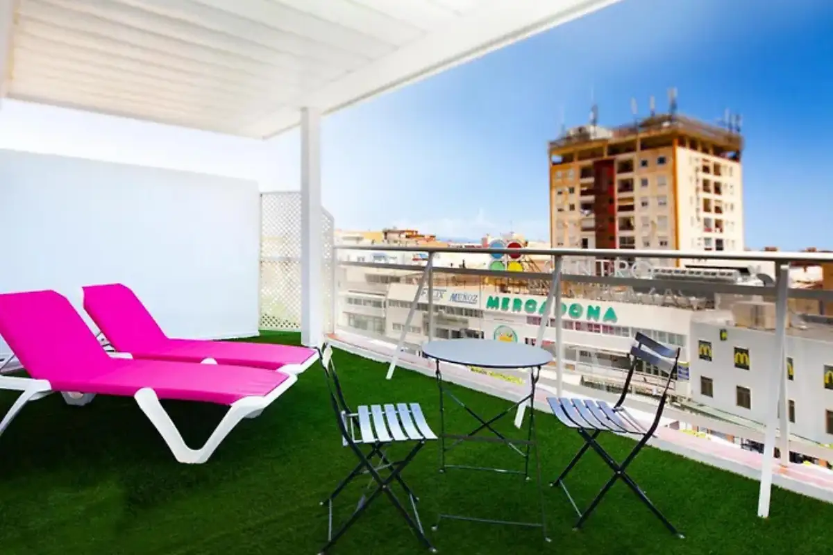 Pink loungers and town view from the terrace at Gastrobar Sireno in Torremolinos