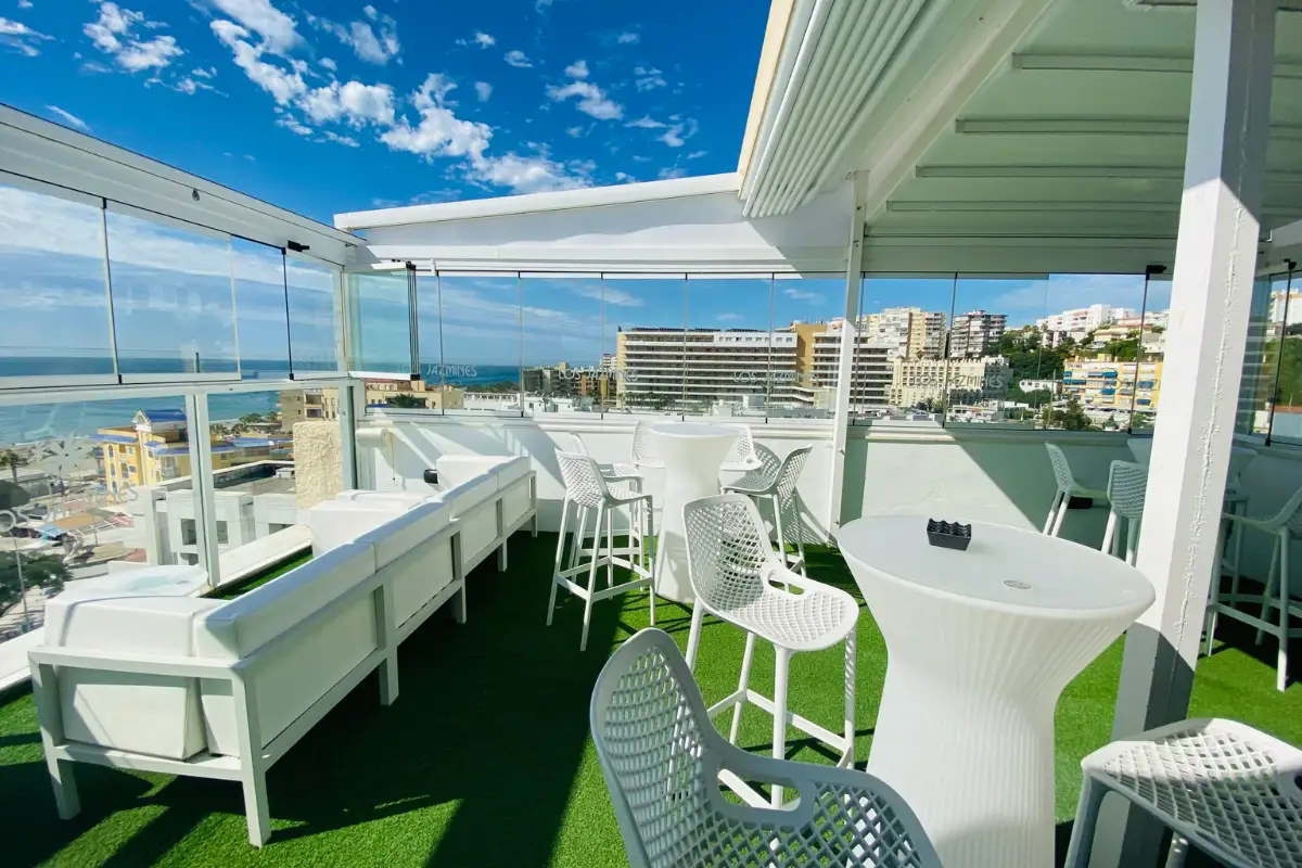 White bar counter and high stools with sea views at Los Jazmines Torremolinos